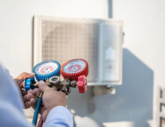 HVAC technician checking air conditioning