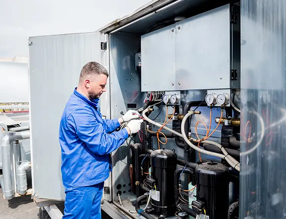 HVAC technician repairing air conditioning