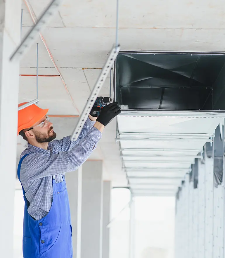 HVAC technician installing ductwork system