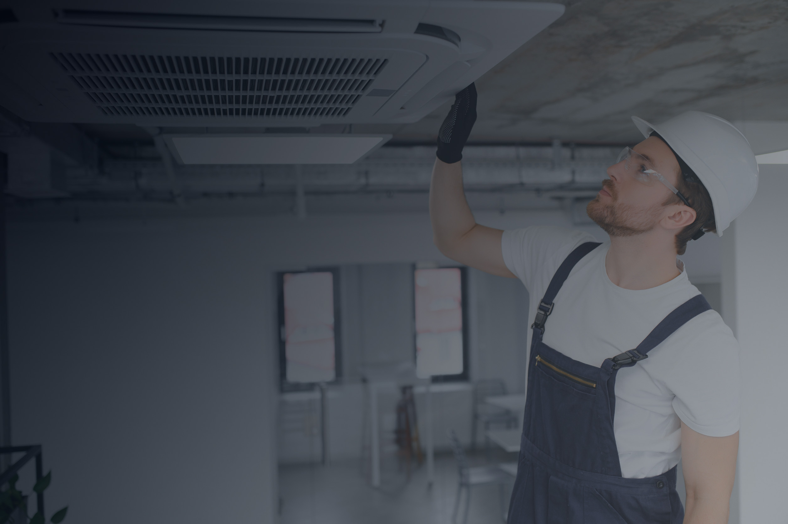 Technician inspecting ceiling air unit